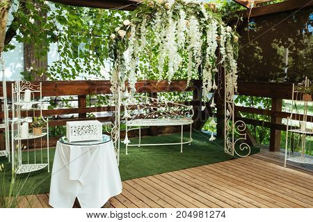 Wedding arch decorated with white hanging flowers