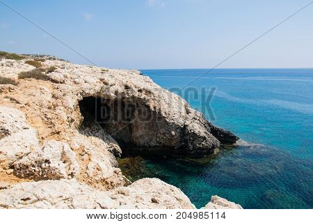 Sea caves of Cavo greco cape. Mediterranean sea landscape skyline
