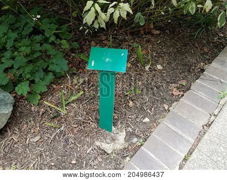 a green metal sign with nothing on it