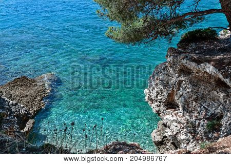 Rocky beach in a small bay with a view from above the cliff