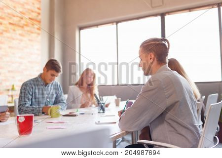 Team at work concept. Group of young business people in smart casual wear working together in creative office.