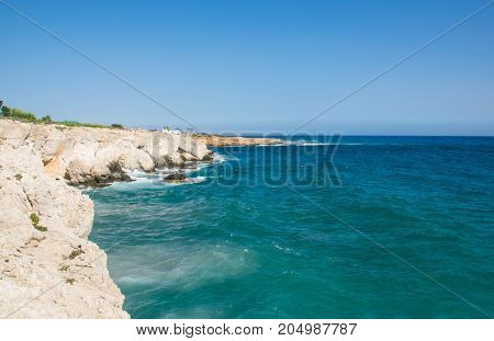 Sea caves of Cavo greco cape. Mediterranean sea landscape skyline
