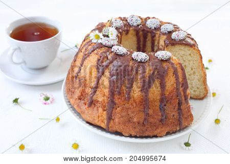 Bundt Cake with Chocolate Fudge Glaze and Chocolate dots circle candy nonpareils with colorful sprinkles on top