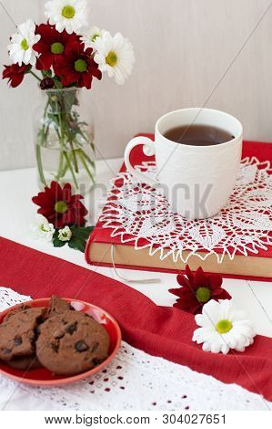 A Tasty Break: A Cup Of Tea And A Plate Of Cookies.