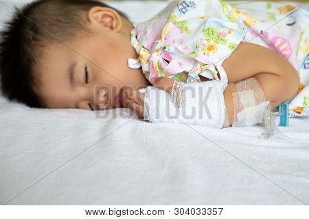 Asian Baby Boy Sleeping On Bed With Infusion Set At Child Department In The Hospital. Children With 