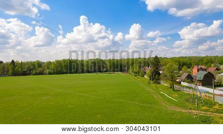Top View Of A Plot Of Agricultural Field And A City In The Distance