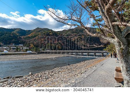 Togetsu-kyo Bridge Over Katsuragawa River With Colourful Forest Mountain Background In Arashiyama Di