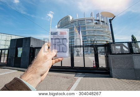 Strasbourg, France - May 26, 2019: Man Hand Holding Voters Car French Carte Electorale At The Entran