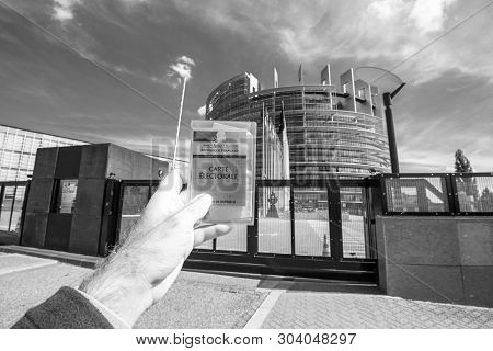 Strasbourg, France - May 26, 2019: Man Hand Holding Voters Car French Carte Electorale At The Entran