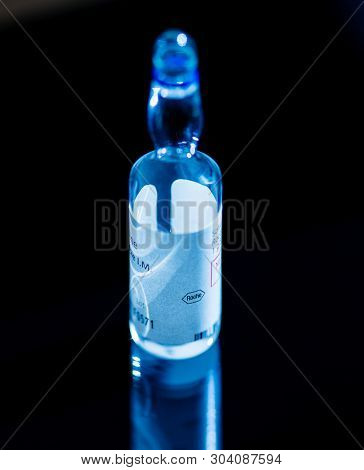 Paris, France - Apr 28, 2019: Single Medical Ampoule With Solution Isolated On Black Background With