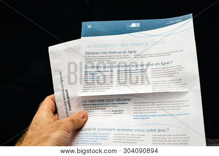 Paris, France - Apr 9, 2019: Man Reading Holding La Declaration Des Revenus Income Statement Instruc