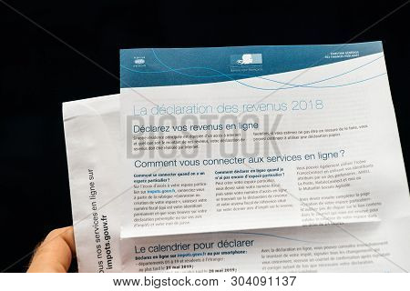 Paris, France - Apr 9, 2019: Man Reading Holding La Declaration Des Revenus Income Statement Instruc