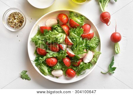 Healthy Radish Salad With Lettuce Leaves On Platel Over White Stone Background. Vitamin Spring Salad