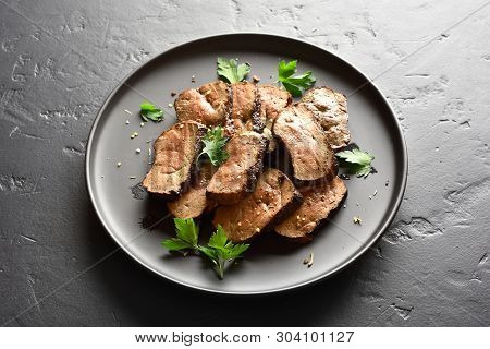 Grilled Sliced Beef Liver On Plate On Black Stone Table. Cooked Liver(offal) From Beef Meat. Close U