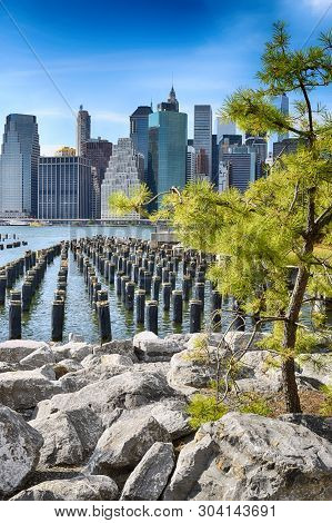 Old Pier Pylons And Downtown Manhattan, New York City.