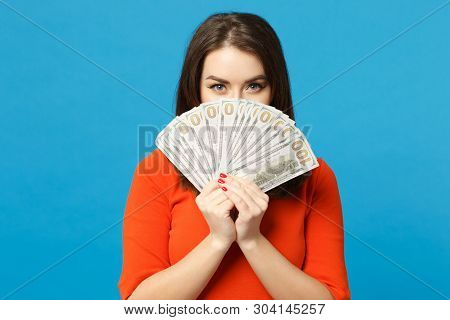 Beautiful Brunette Young Woman Wearing Red Orange Dress Holding Fan Of Cash Money In Dollar Banknote