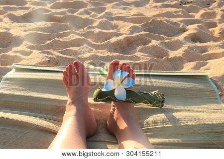 Female Feet On The Sand Sith A Hawaiian, Flower Band