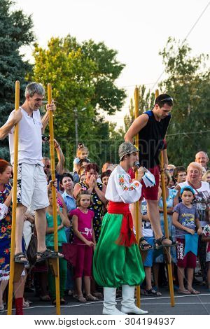 Men Compete In Walking On Wooden Stilts