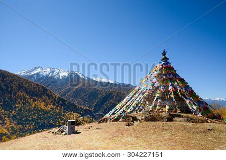 Colorful Tibetan Flags And Snow Mountain At Siguniang Scenic Area In Autumn Season,chengdu, China.