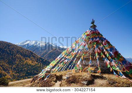 Colorful Tibetan Flags And Snow Mountain At Siguniang Scenic Area In Autumn Season,chengdu, China.