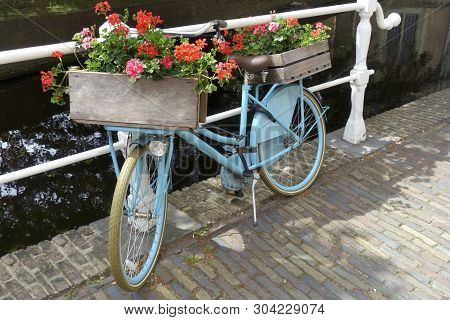 Old-fashioned City Bike Near A Bridge Over Canal In The Old Town Of Delft, Holland
