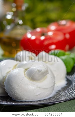 Twisted To Form A Plait Treccia Mozzarella Italian Soft Cheese Served With Fresh Basil And Tomatoes