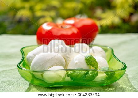 Twisted To Form A Plait Treccia Mozzarella Italian Soft Cheese Served With Fresh Basil And Tomatoes