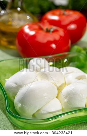 Twisted To Form A Plait Treccia Mozzarella Italian Soft Cheese Served With Fresh Basil And Tomatoes