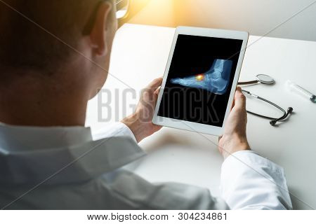 Doctor Holding A Digital Tablet With X-ray Of Foot With A Pain In The Top