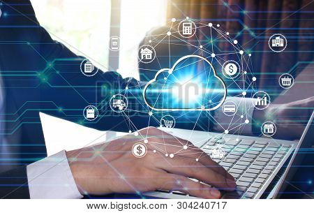 Businessman Hand Use Laptop Computer With Virtual Cloud Computing Icon Over The Network Connection, 