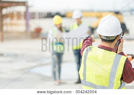 Foreman 3 People Are Sitting To See A Blueprint About The Factory Building Structure On The Job Site
