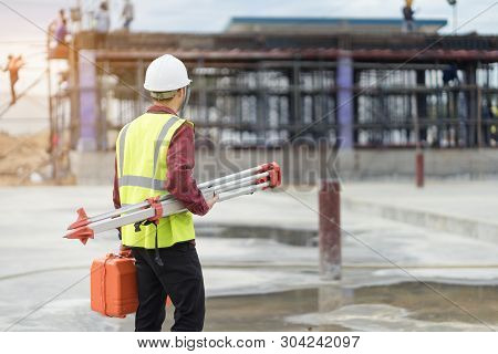 Surveyor Engineer With Theodolite At Construction Site During Surveying Work.engineer And Architect 