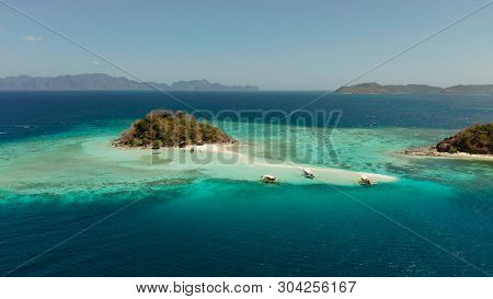 Aerial Seascape Tropical Island And Sand Beach, Turquoise Water And Coral Reef. Malacory Island, Phi