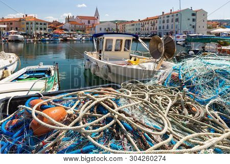 Scenic Harbour With Boats And Brightly Coloured Houses On The Fishing Net Waterfront In Izola - Isol