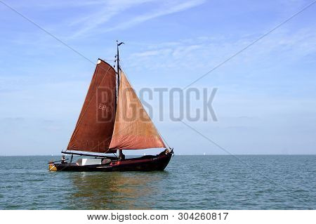 Almere, The Netherlands - June 1, 2019: Historic Dutch Botter Eb58 Sailing By On A Sunny Day.