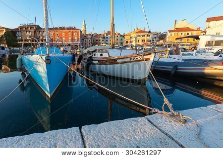 Izola, Slovenia - May 1, 2019: Scenic Harbour With Boats And Brightly Coloured Houses On The Sunset 