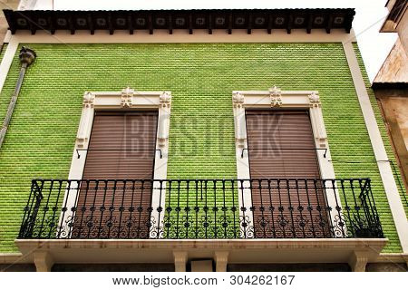 Old Colorful And Majestic Tiled Facades With Vintage Streetlight In Elche, Alicante, Spain. El Raval