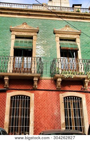 Old Colorful And Majestic Tiled Facades With Vintage Streetlight In Elche, Alicante, Spain. El Raval