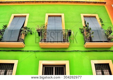 Old Colorful And Majestic Tiled Facades With Vintage Streetlight In Elche, Alicante, Spain. El Raval