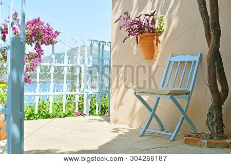Mediterranean Style Terrace With Sea Scape, Chair, Flowers.