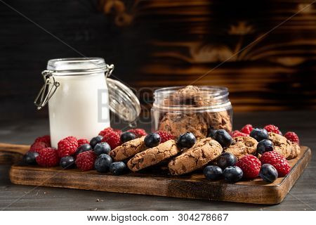 Blueberries, Raspberries And Biscuits Placed Over Wooden Platter