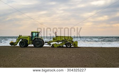 Malaga, Spain - January 29, 2018. Tractor On The Sandy Beach Cleaning