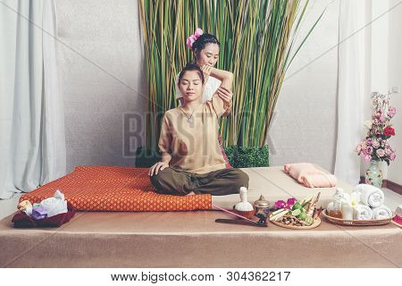 Thai Masseuse Doing Massage For Lifestyle Woman In Spa Salon. Asian Beautiful Woman Getting Thai Her