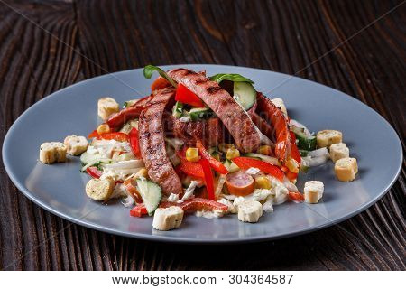 Salad With Grilled Sausage Paprica Cucumber And Croutons