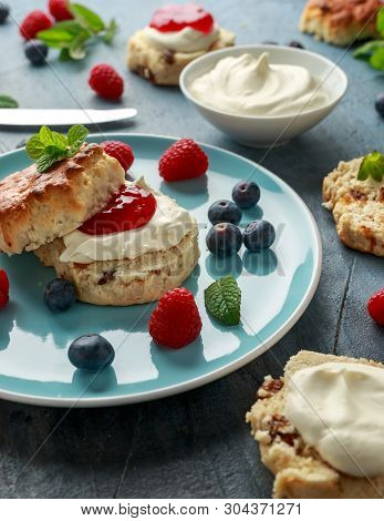 Classic English Scones With Clotted Cream, Strawberries Jam And Other Fruit