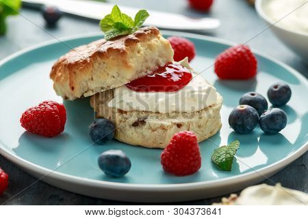 Classic English Scones With Clotted Cream, Strawberries Jam And Other Fruit