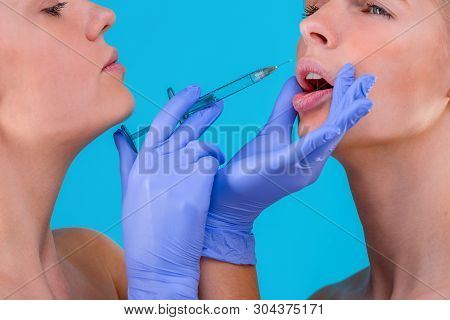 Face Of A Girl With Smooth Skin Without Wrinkles Makes Beauty Shots. Syringe Next To The Face, Skin 