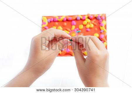 A Child Kneads Plasticine And Sculpts A Juicy, Bright Multi-colored Rug. Tutoring With Children.