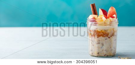 Overnight Oats, Bircher Muesli With Apple, Cinnamon And Honey. Blue Wooden Background. Copy Space