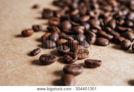 Coffee Beans On Braun Background. Close Up.